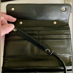Black faux leather crossbody wallet with a removable strap